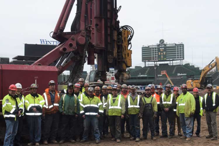 Workers in front of construction equipment